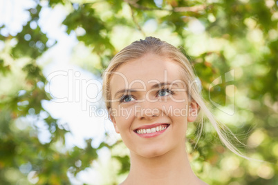 Cheerful young woman standing in a park