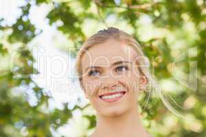 Cheerful young woman standing in a park