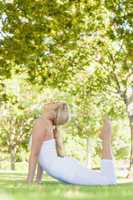 Beautiful young woman wearing white clothes doing yoga