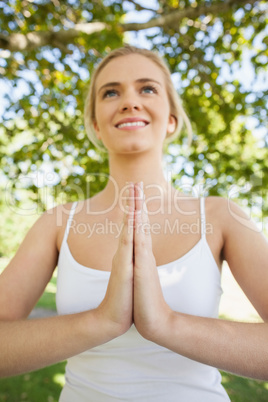 Cheerful fit woman doing yoga in sukhasana pose