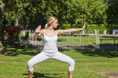 Serious blonde woman doing yoga