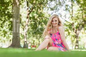 Content blonde woman sitting in a park