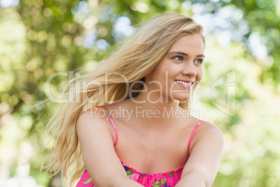 Beautiful casual woman sitting on a lawn