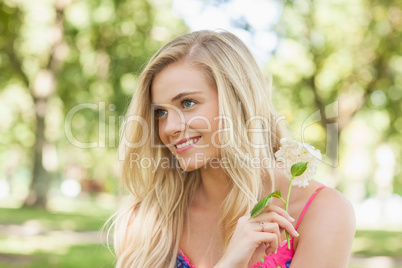 Content young woman holding a flower