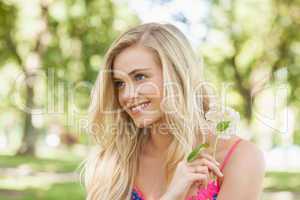 Content young woman holding a flower