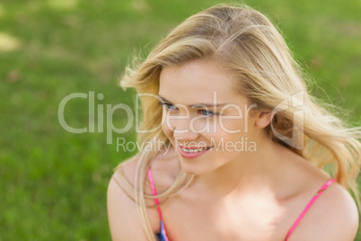 Attractive young woman sitting on a lawn