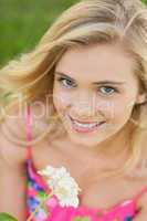 Portrait of lovely woman holding a white flower