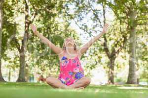 Cheerful blonde woman relaxing on a lawn