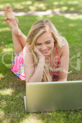 High angle view of content young woman using her notebook