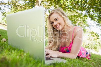 Amused attractive woman using her notebook