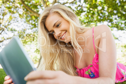 Peaceful amused woman using her tablet