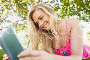 Peaceful amused woman using her tablet