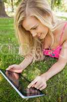 Blonde young woman using her tablet