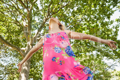 Cheerful blonde woman standing on a lawn