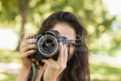 Pretty brunette woman taking a picture