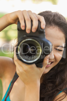 Smiling young woman taking a picture