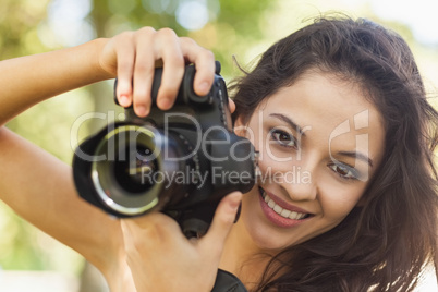 Gorgeous brunette woman holding her camera