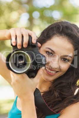 Happy attractive woman holding her camera