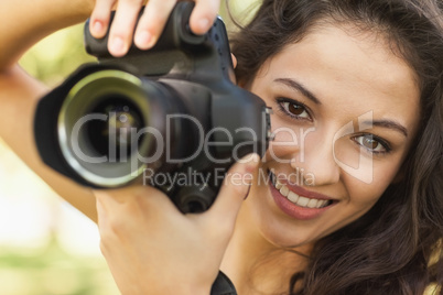 Gorgeous calm woman holding her camera