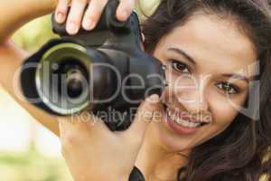 Gorgeous calm woman holding her camera