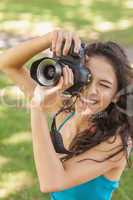 High angle view of cheerful young woman taking a picture