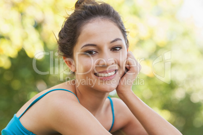 Portrait of gorgeous woman sitting in a park