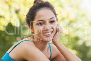 Portrait of gorgeous woman sitting in a park