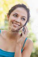 Lovely brunette woman calling with her smartphone
