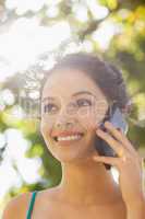 Cheerful young woman calling with her smartphone