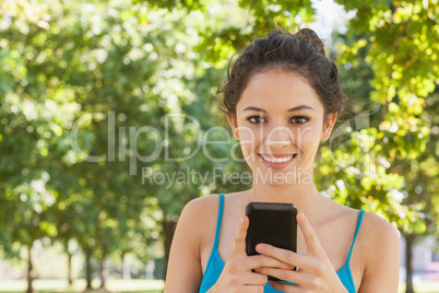 Portrait of young woman texting with her smartphone