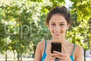 Portrait of young woman texting with her smartphone