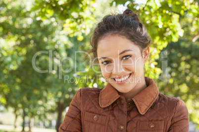 Gorgeous woman posing wearing a coat in a park