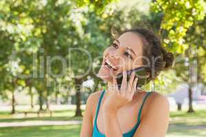 Happy young woman phoning with her smartphone
