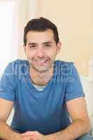 Casual smiling man relaxing on couch