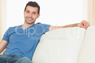 Casual happy man relaxing on couch