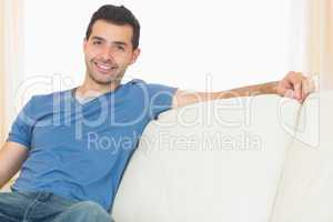 Casual happy man relaxing on couch