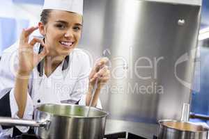 Young cheerful chef showing ok sign