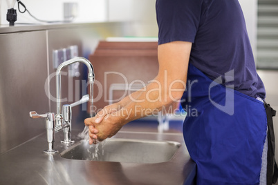 Kitchen porter washing his hands