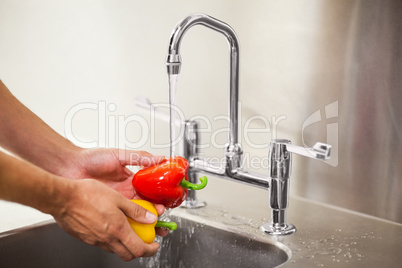 Kitchen porter washing vegetable