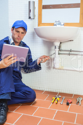 Focused plumber consulting tablet