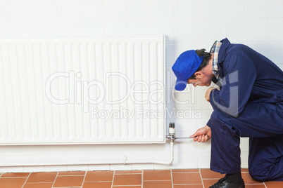 Handyman repairing a radiator