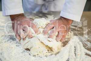 Close up of chef kneading dough