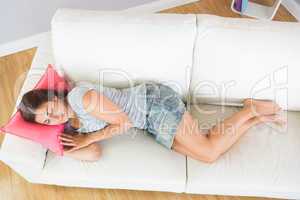 Lovely casual woman napping on her couch