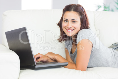 Portrait of cute brunette woman working with her notebook