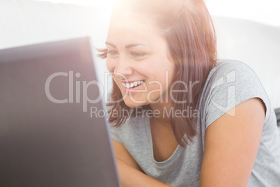 Joyful casual woman working with her notebook