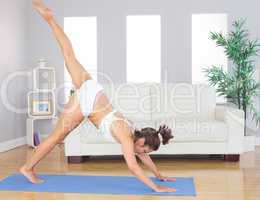 Sporty woman stretching her body with yoga pose on an exercise m