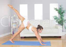 Slim woman stretching her body in yoga pose