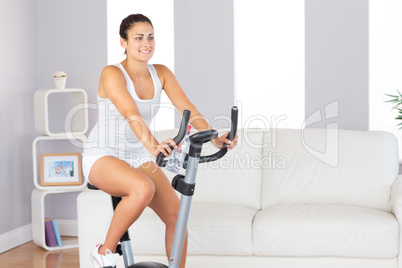 Beautiful fit woman training on an exercise bike