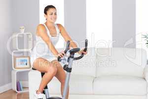 Beautiful fit woman training on an exercise bike