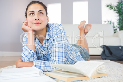 Gorgeous slender student lying thoughtful on the floor in the li